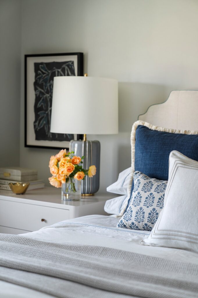 Night stand with flowers in primary suite renovation by Melinda Mandell
